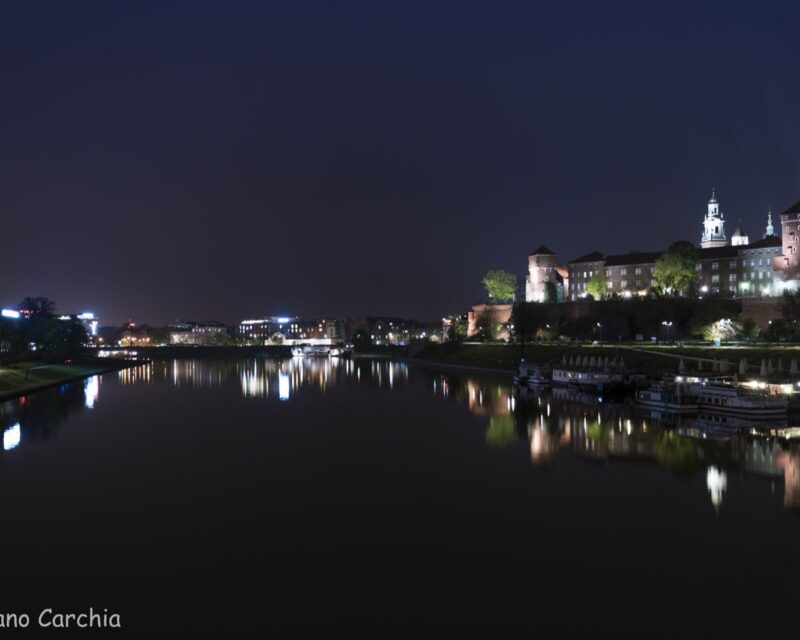 Wawel Royal Castle at night above the Vistula
