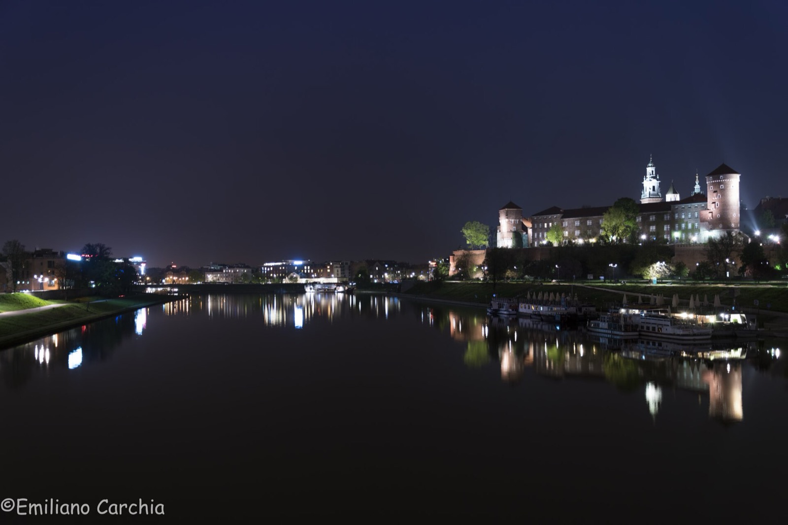 Wawel Royal Castle at night above the Vistula